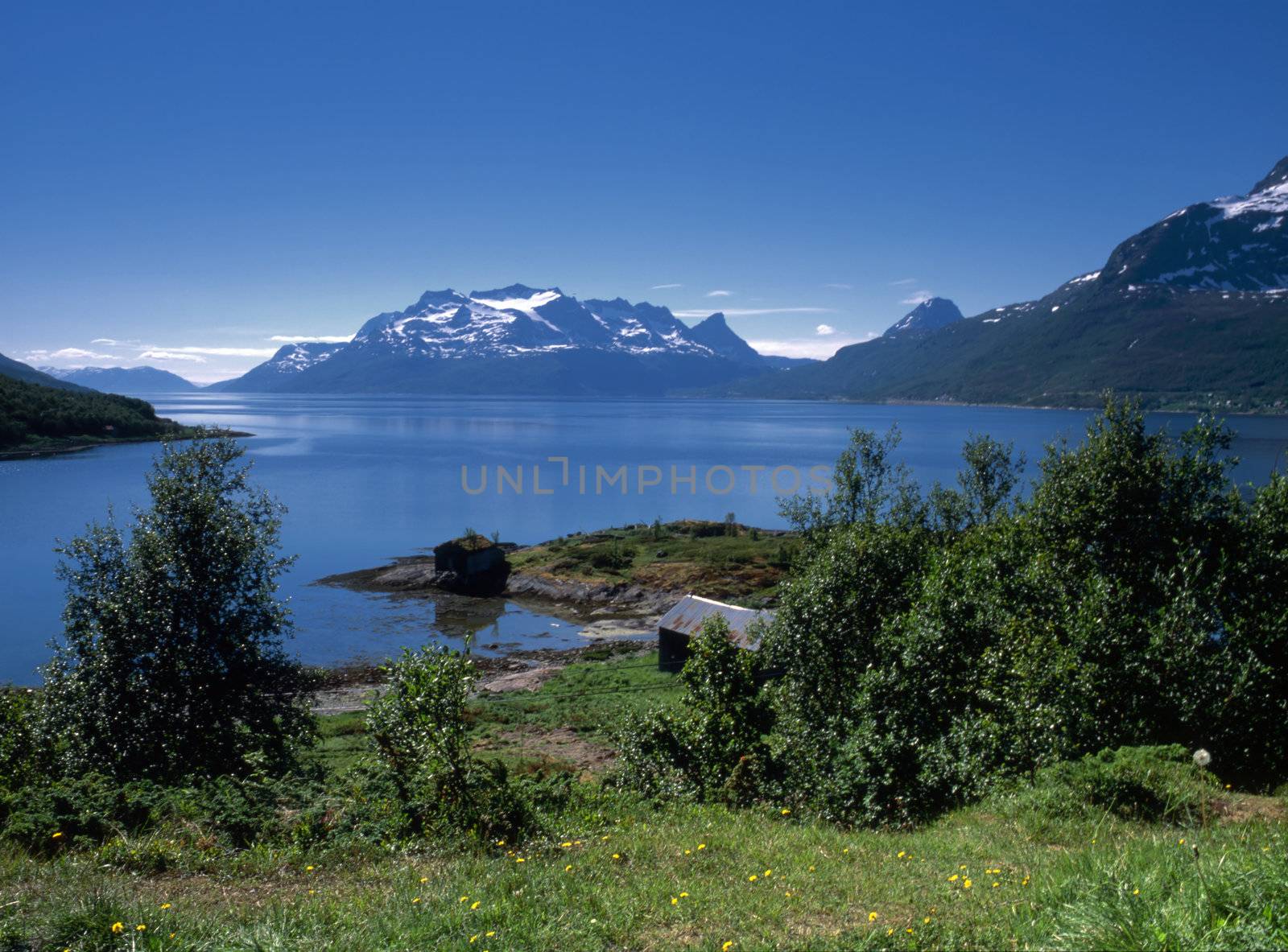 Beautiful view of ocean fjord in Norway with snow mountains