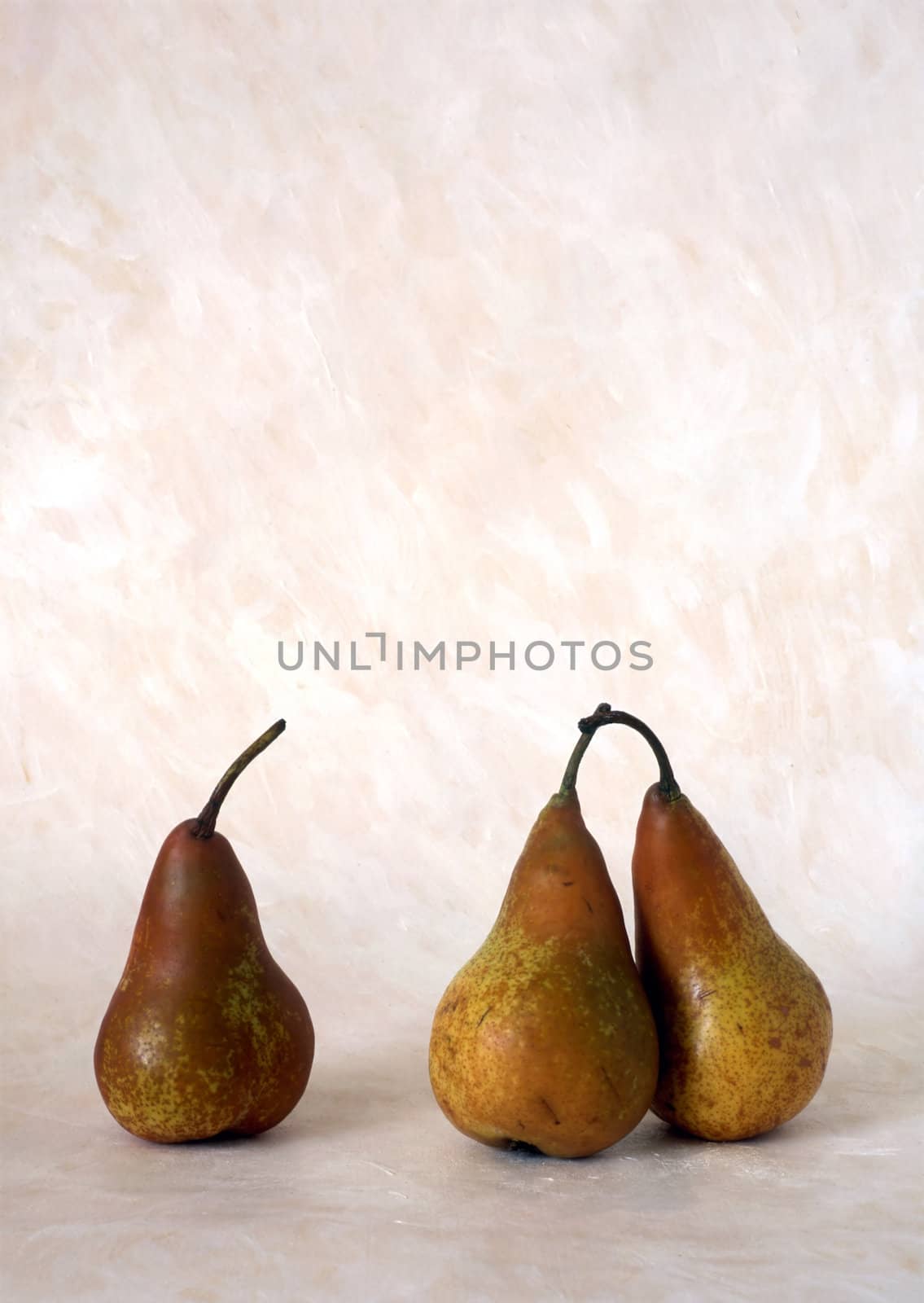 Three red pears isolated on painted background