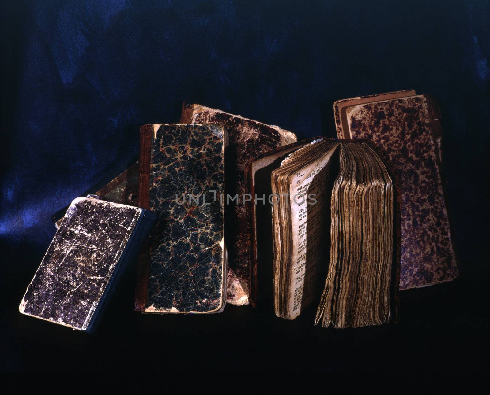 Pile of old books isolated on dark background