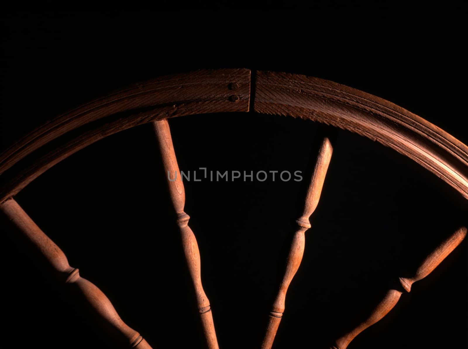wheel of vintage wooden spinning closeup in dark