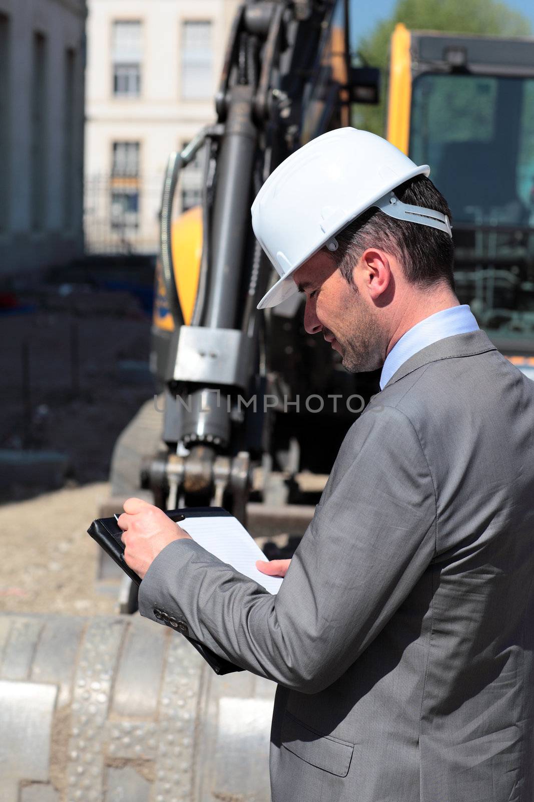 young man with hardhat on building site