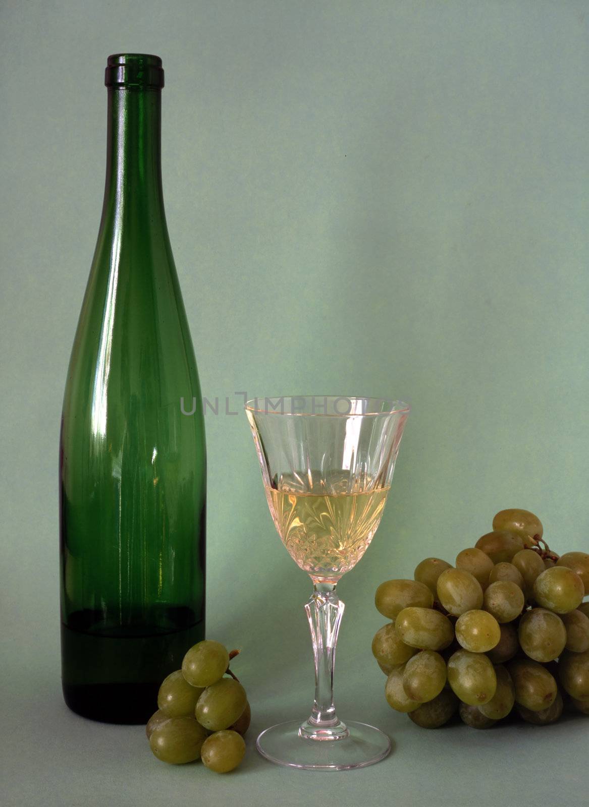 Wine,glass and frapes isolated on green background