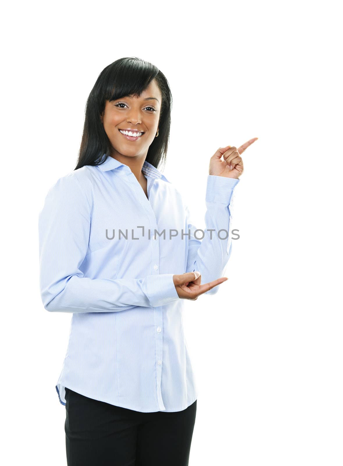 Smiling black woman pointing to the side isolated on white background