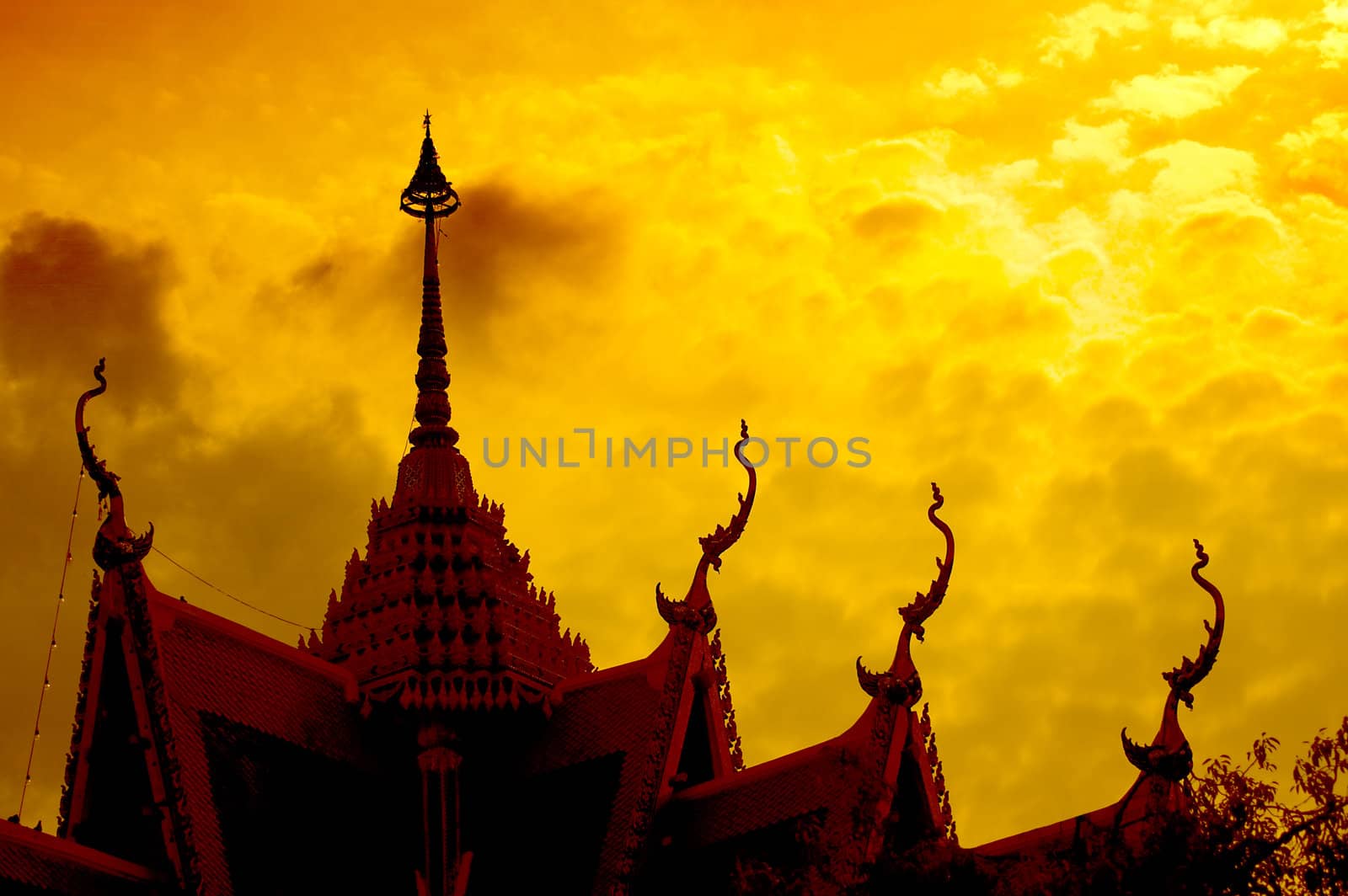 Dramatic sunset with buddhist temple silhouette, Thaialnd