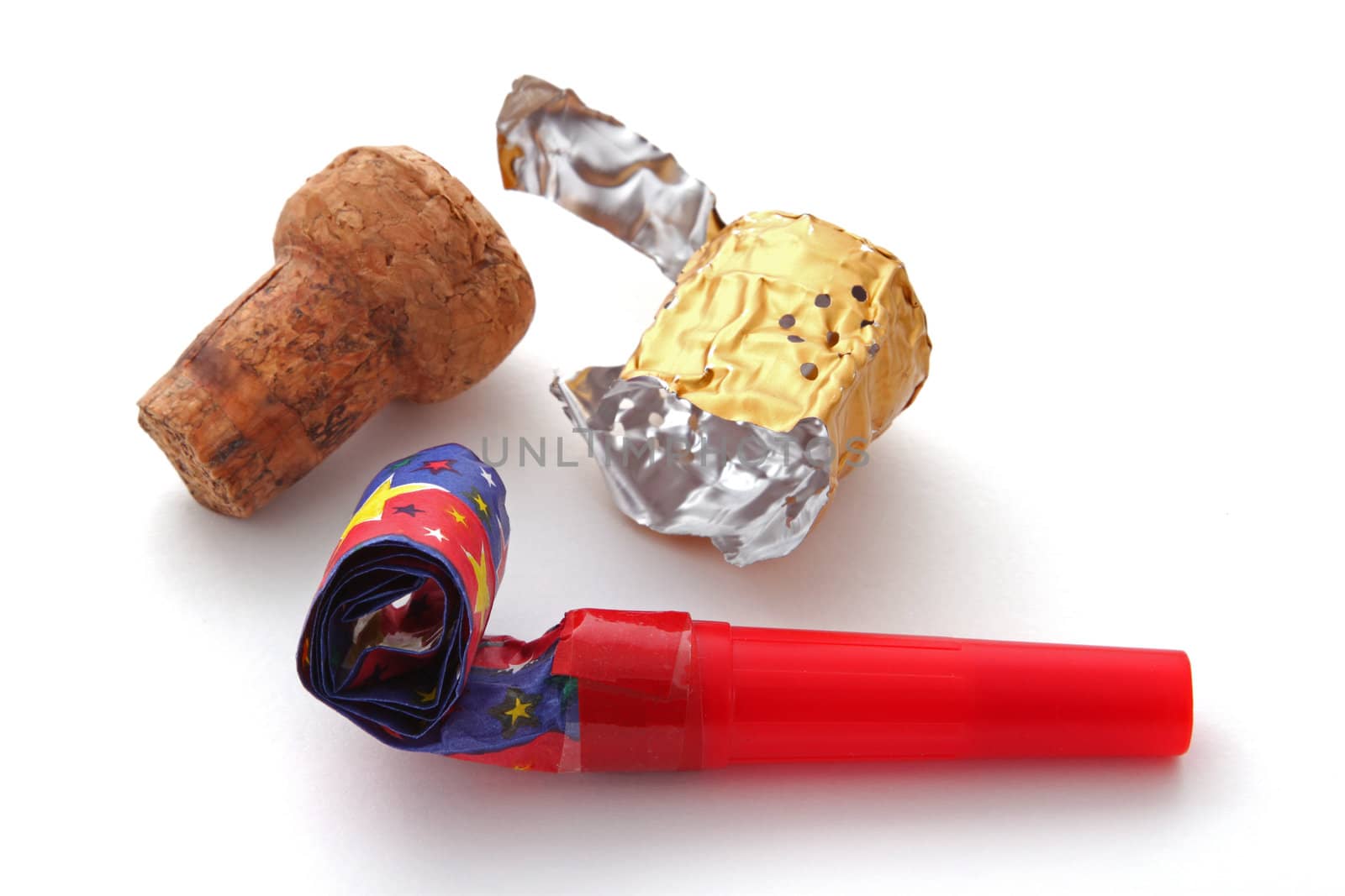 Champagne cork, foil and blower on a plain white background.