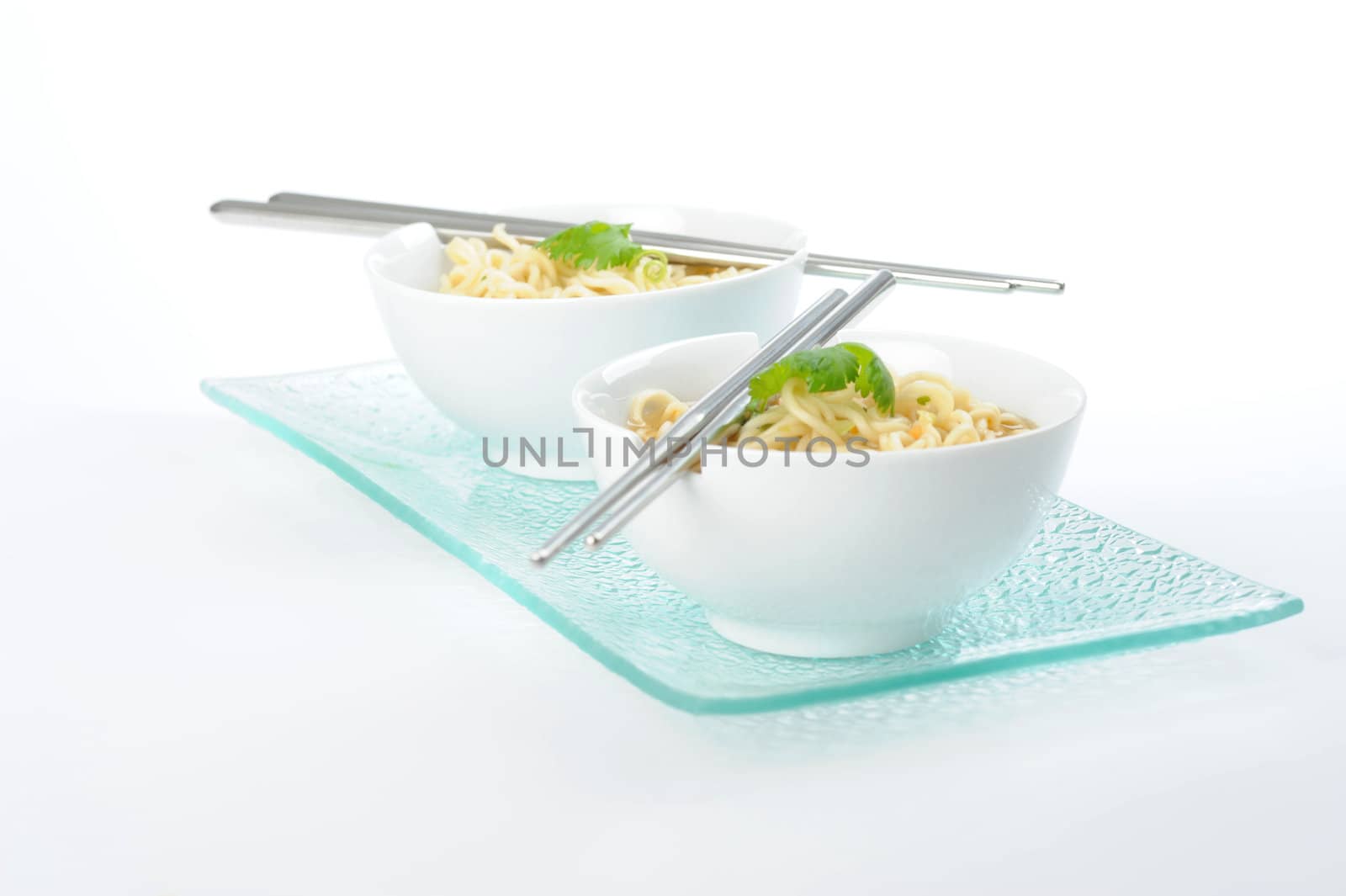 Bowls of oriental rice noodles with chopsticks.