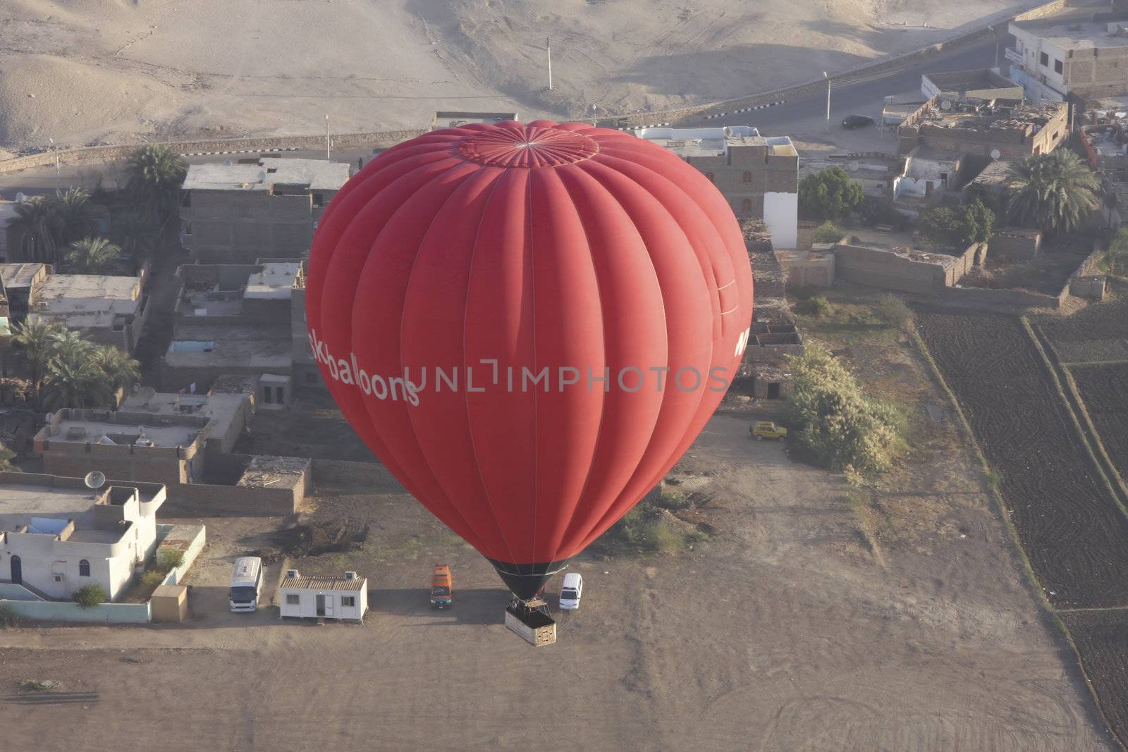 one red hot air balloon taking off in Luxor Egypt, aerial shot
