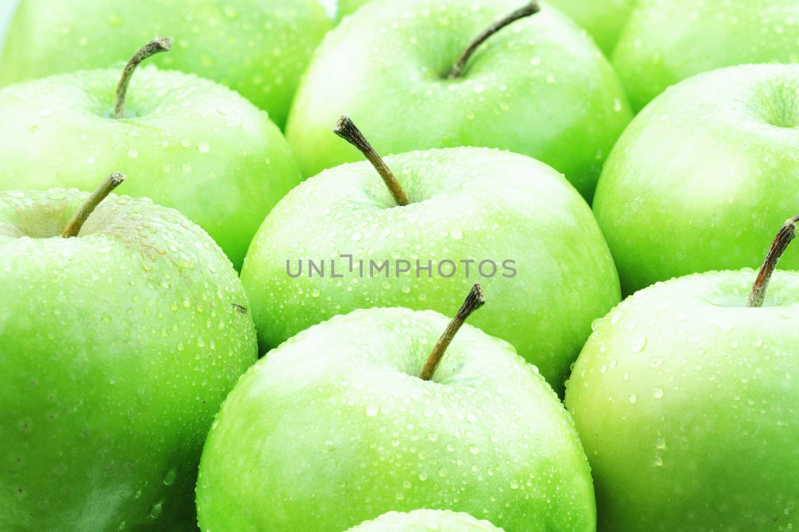 Freshly washed green apples ready to be eaten.