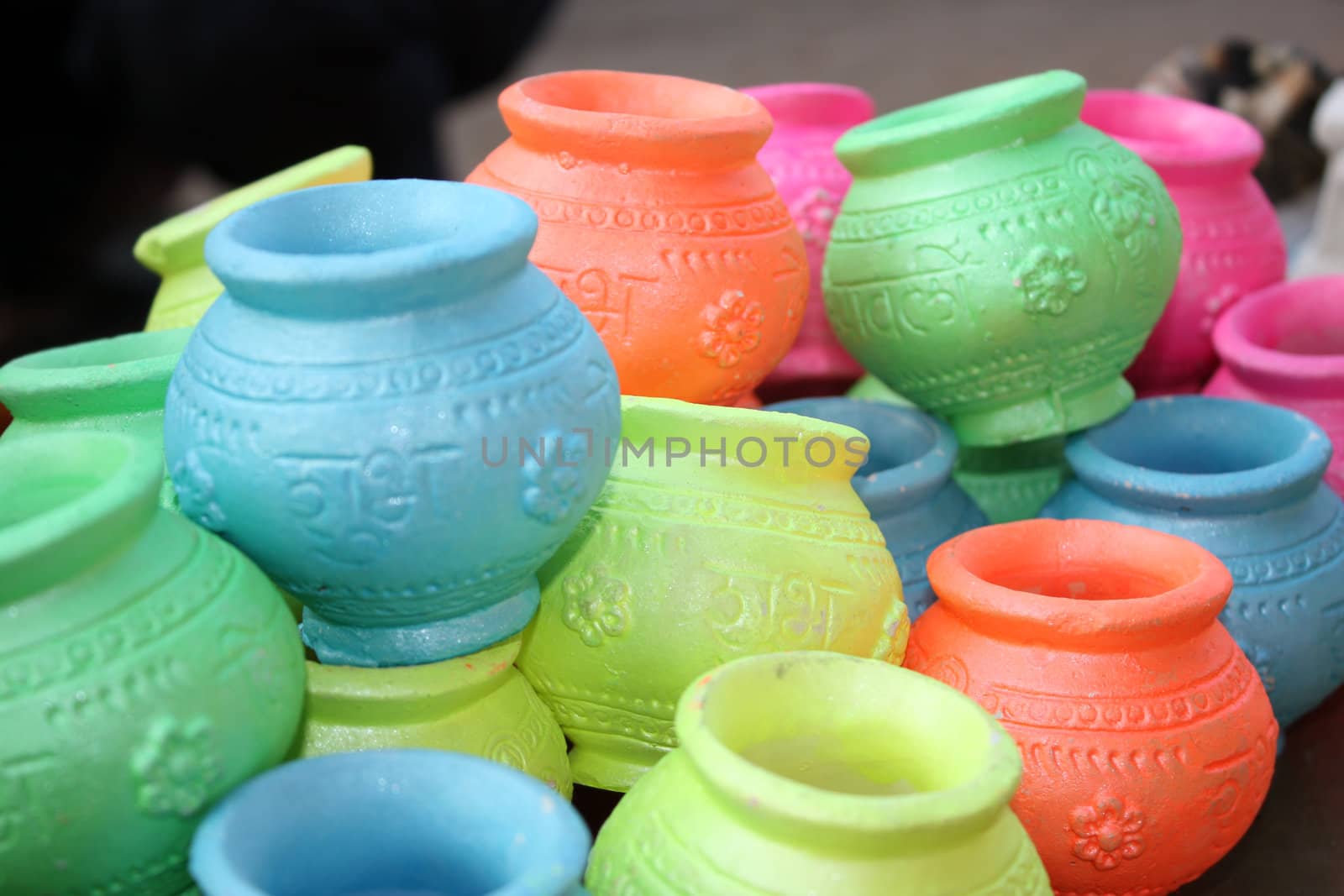 A set of brightly colored pots with traditional religious design for Diwali festival.