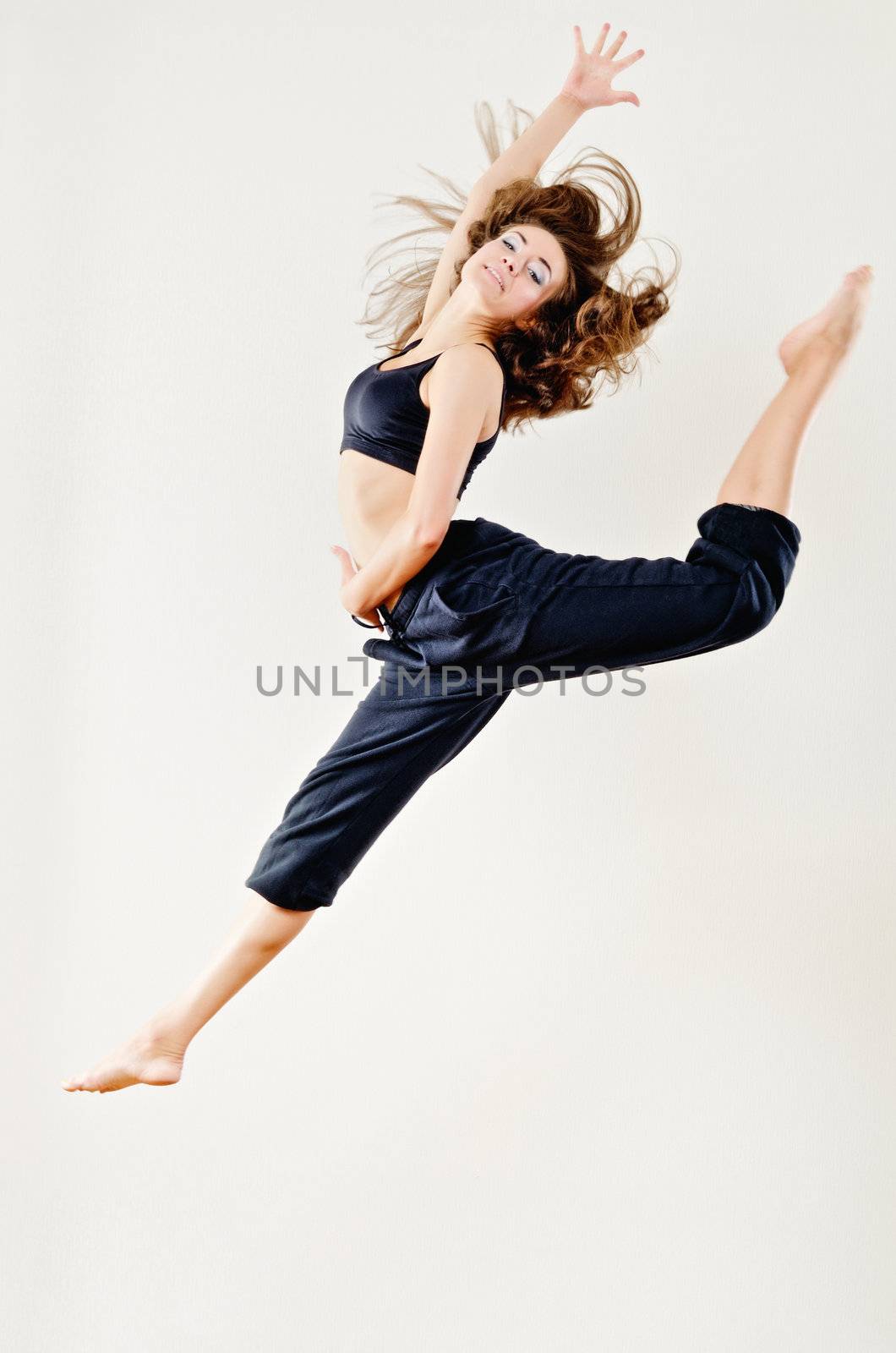 Attractive young woman jumping on white background