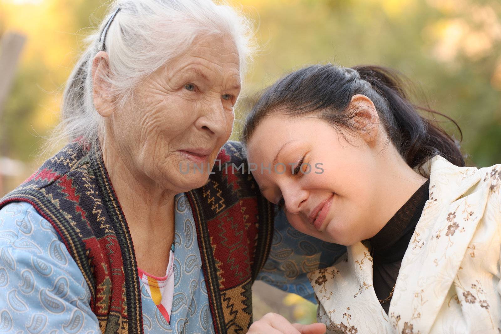 The grandmother with the grand daughter. A photo on outdoors