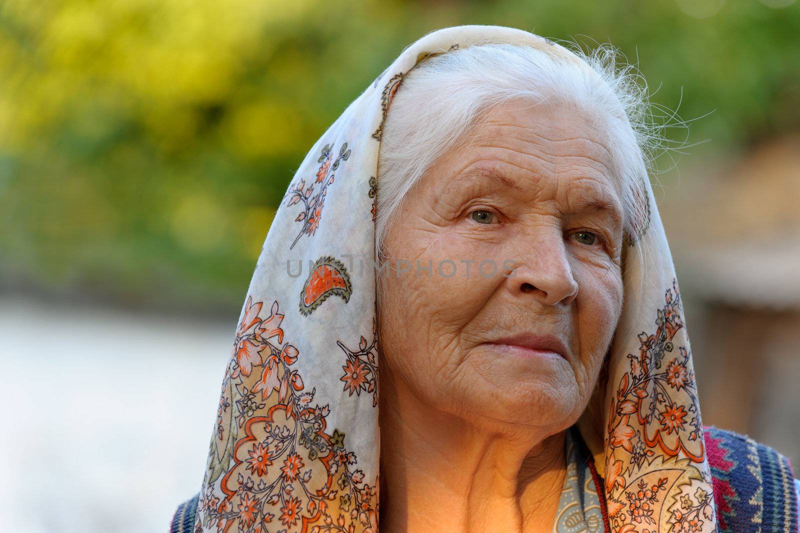 Portrait of the elderly woman. A photo on outdoors