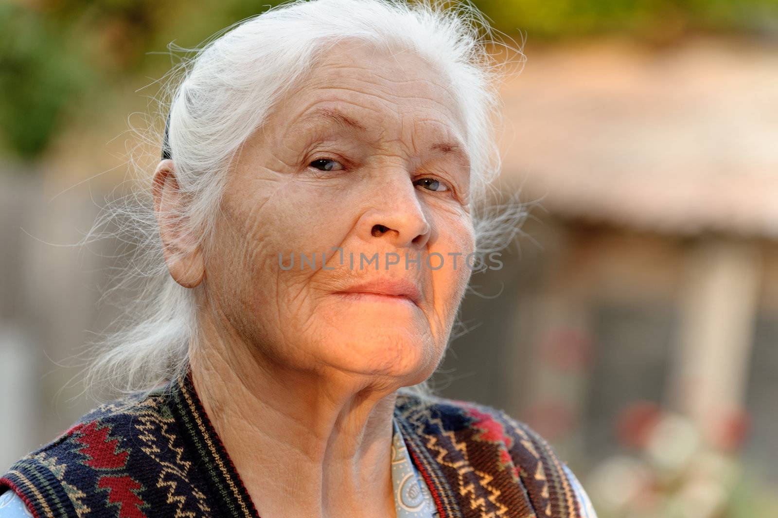 Portrait of the elderly woman. A photo on outdoors