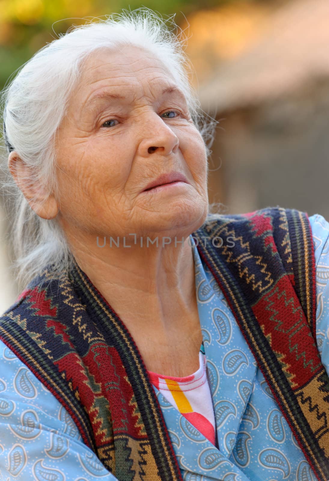 Portrait of the elderly woman. A photo on outdoors