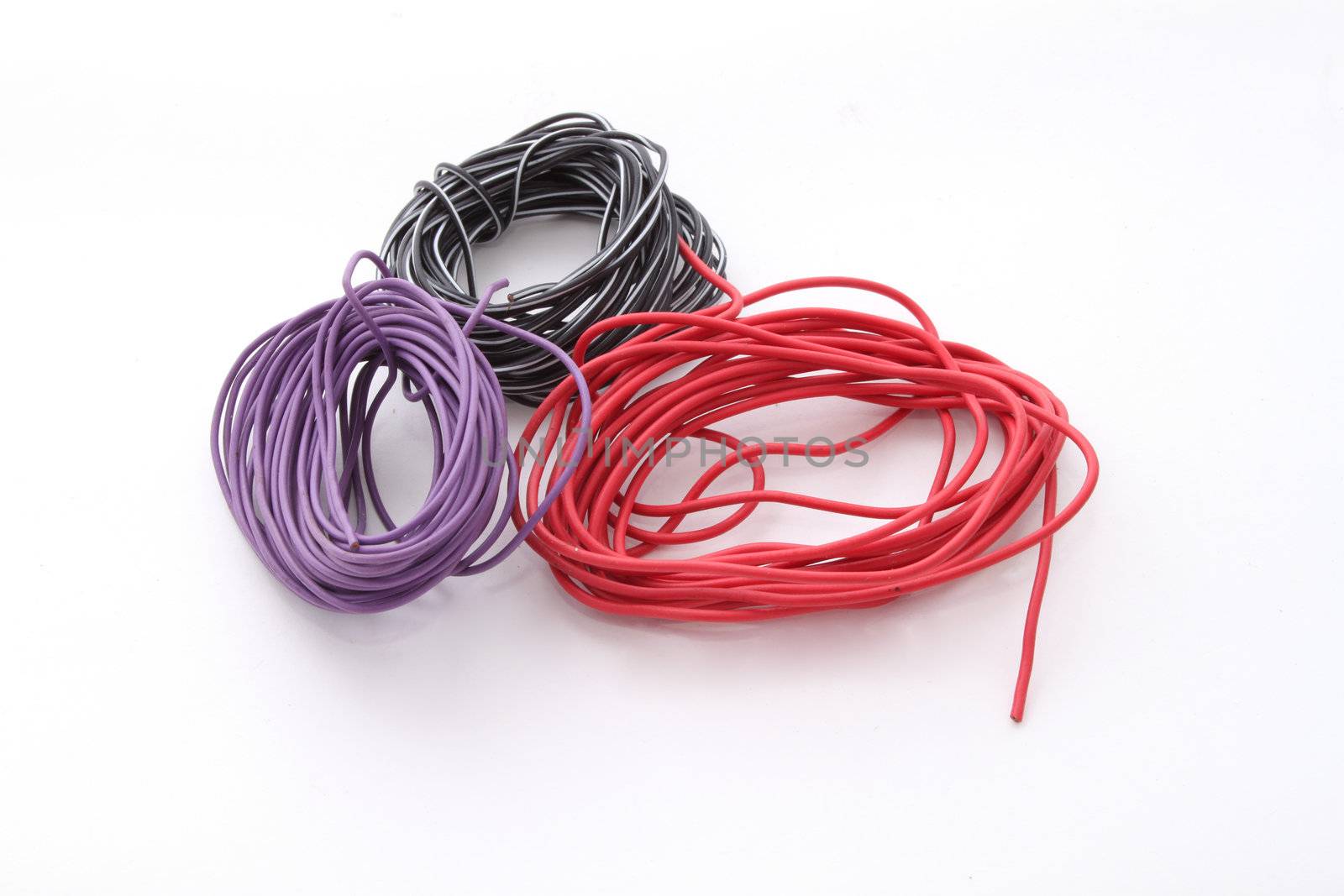 Close up of electric wire on a plain white background.