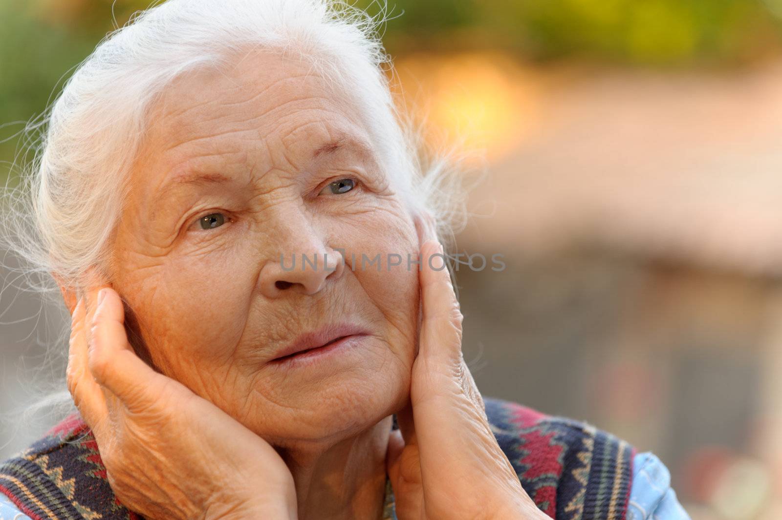 Portrait of the elderly woman. A photo on outdoors