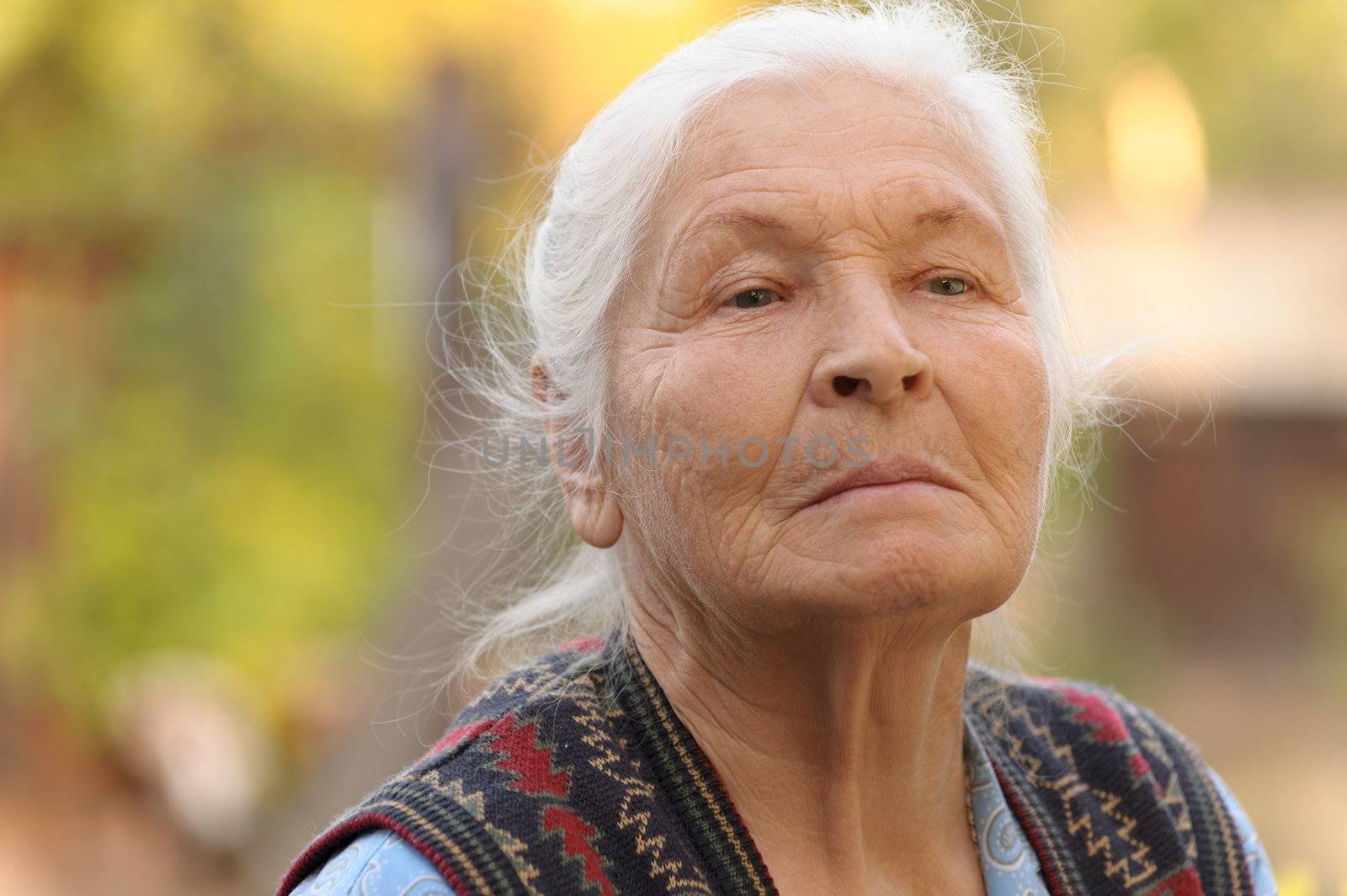 Portrait of the elderly woman. A photo on outdoors