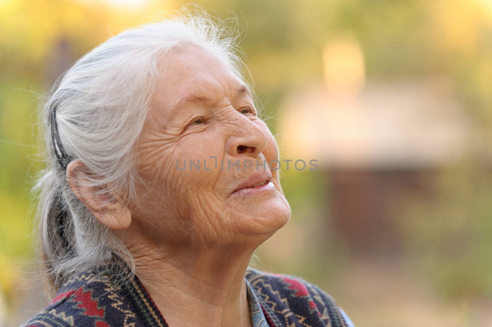 Portrait of the elderly woman. A photo on outdoors