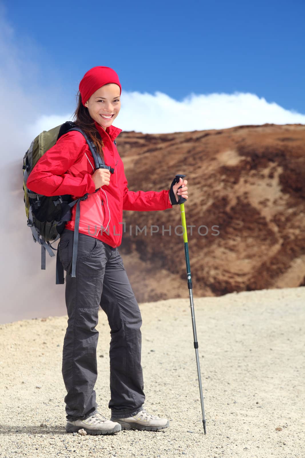 Hiking. Young woman hiker portrait. Beautiful outdoors person in walking on the volcano Teide, Tenerife, Canary Islands, Spain.