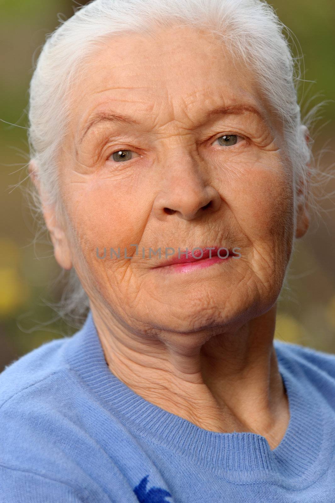 Portrait of the elderly woman. A photo on outdoors