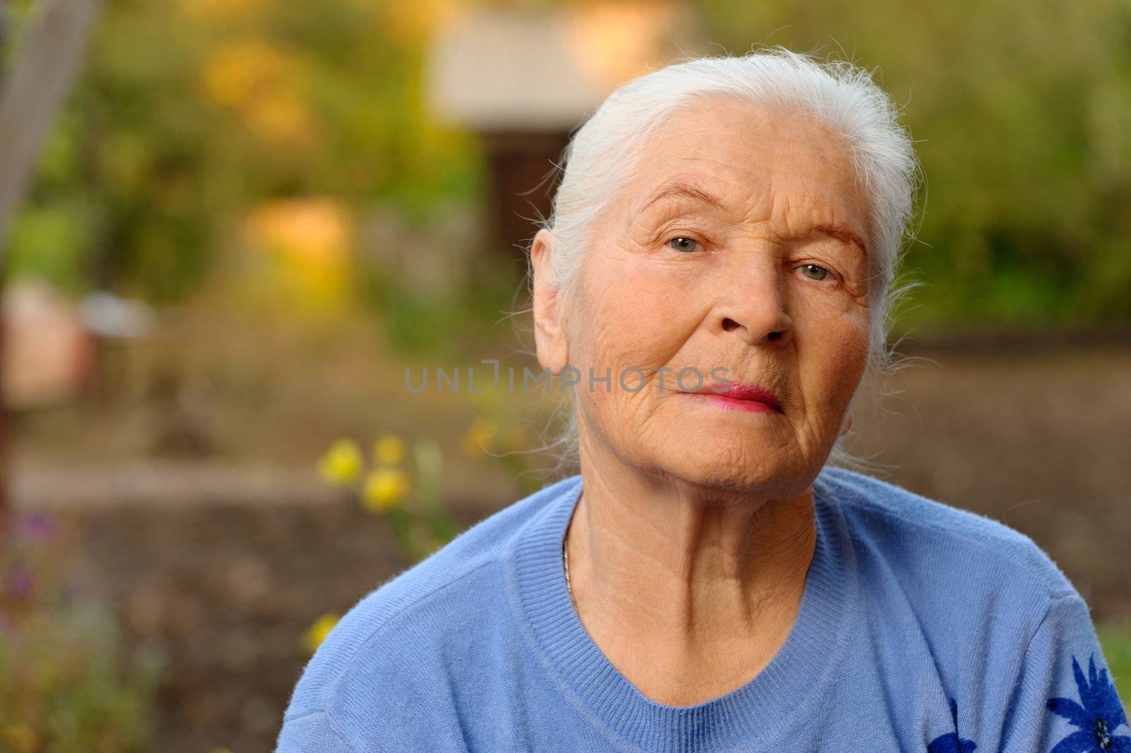 Portrait of the elderly woman. A photo on outdoors