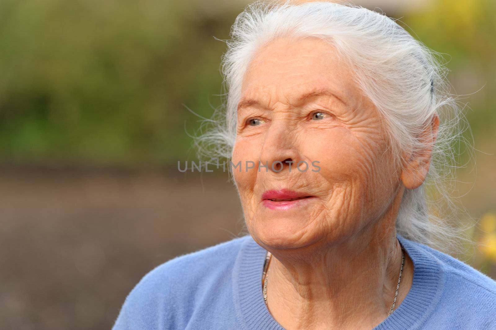 Portrait of the elderly woman. A photo on outdoors