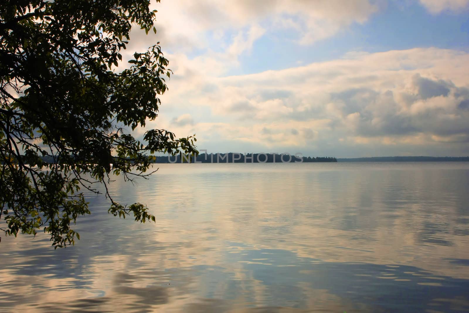 Late afternoon sun and clouds on lake