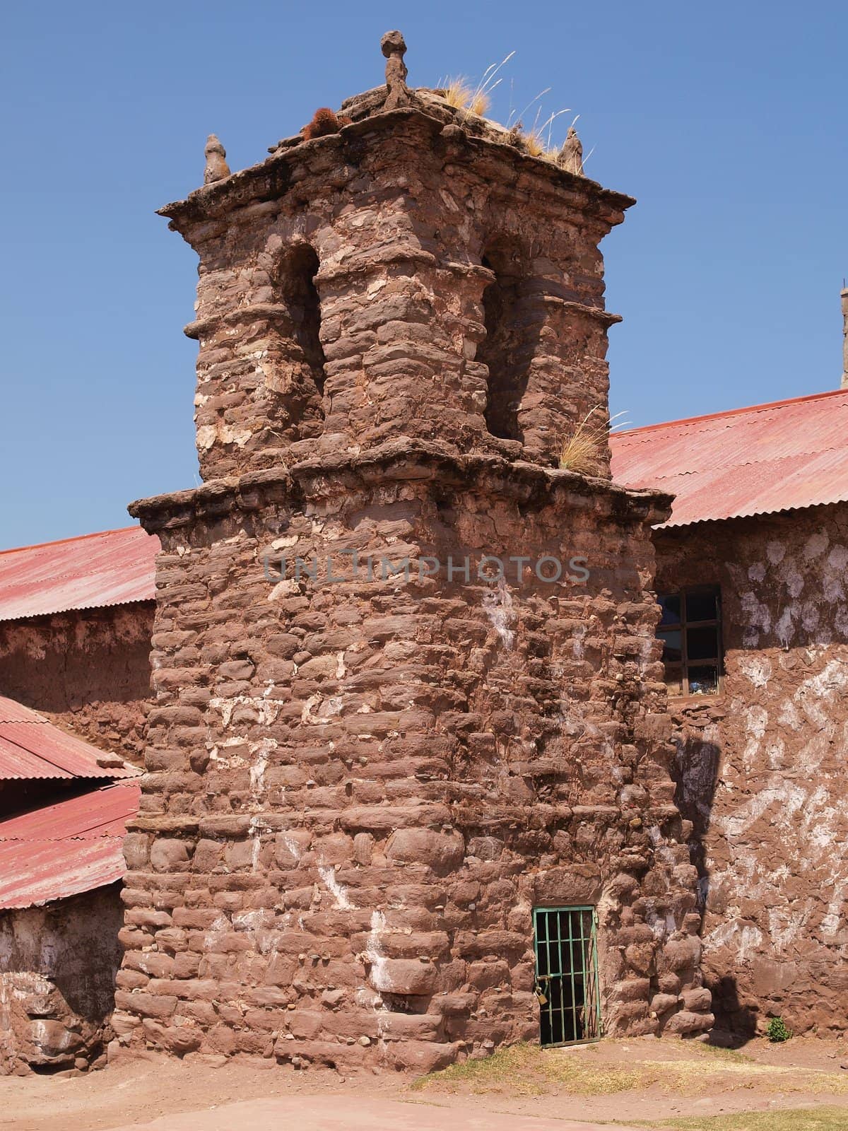 old tower of christian church, build from stone, lake titicaca, peru