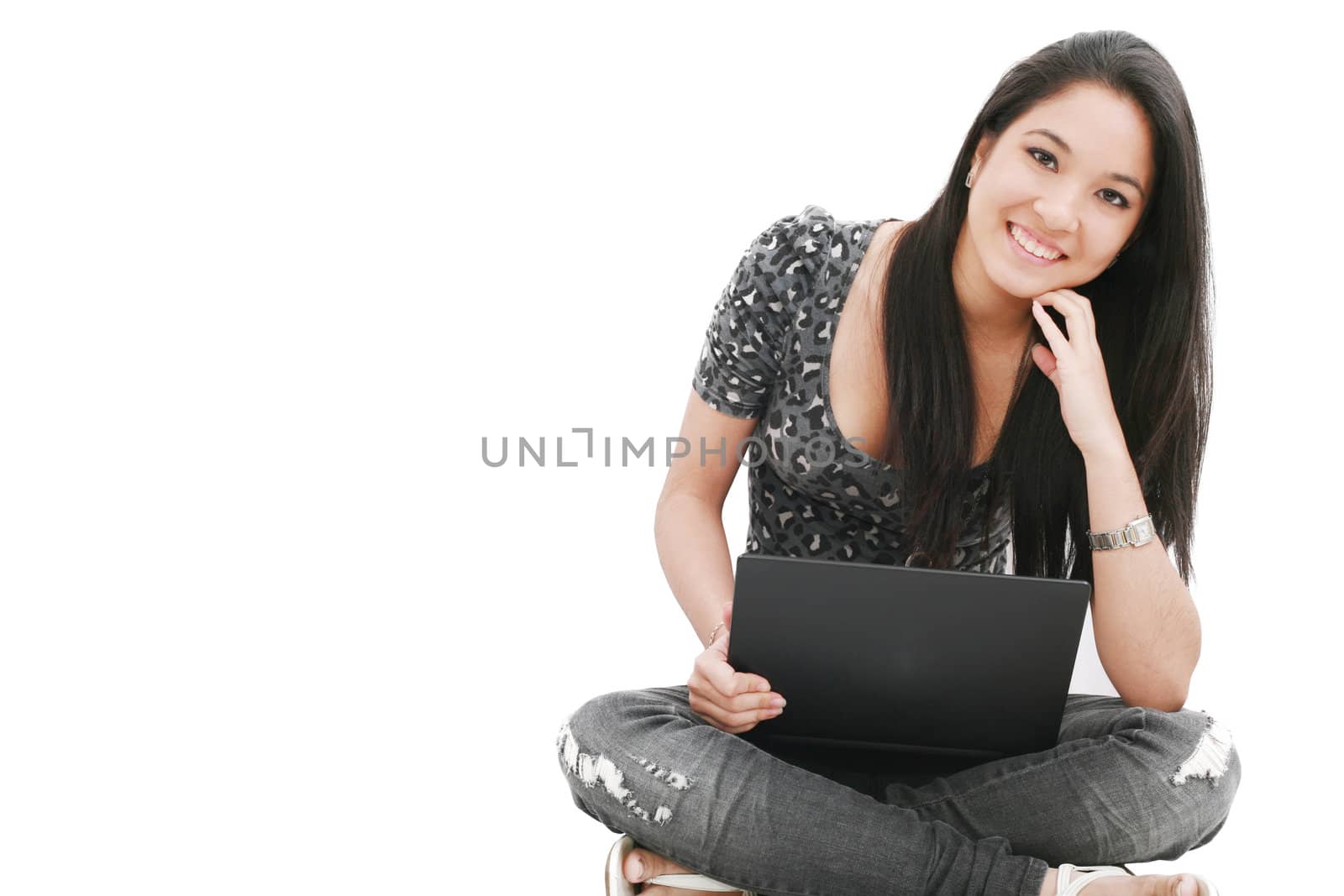 attractive young female sitting on the floor using laptop by dacasdo