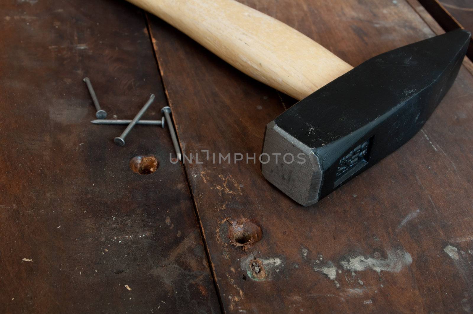 Hammer and Nails on Old Wooden Planks