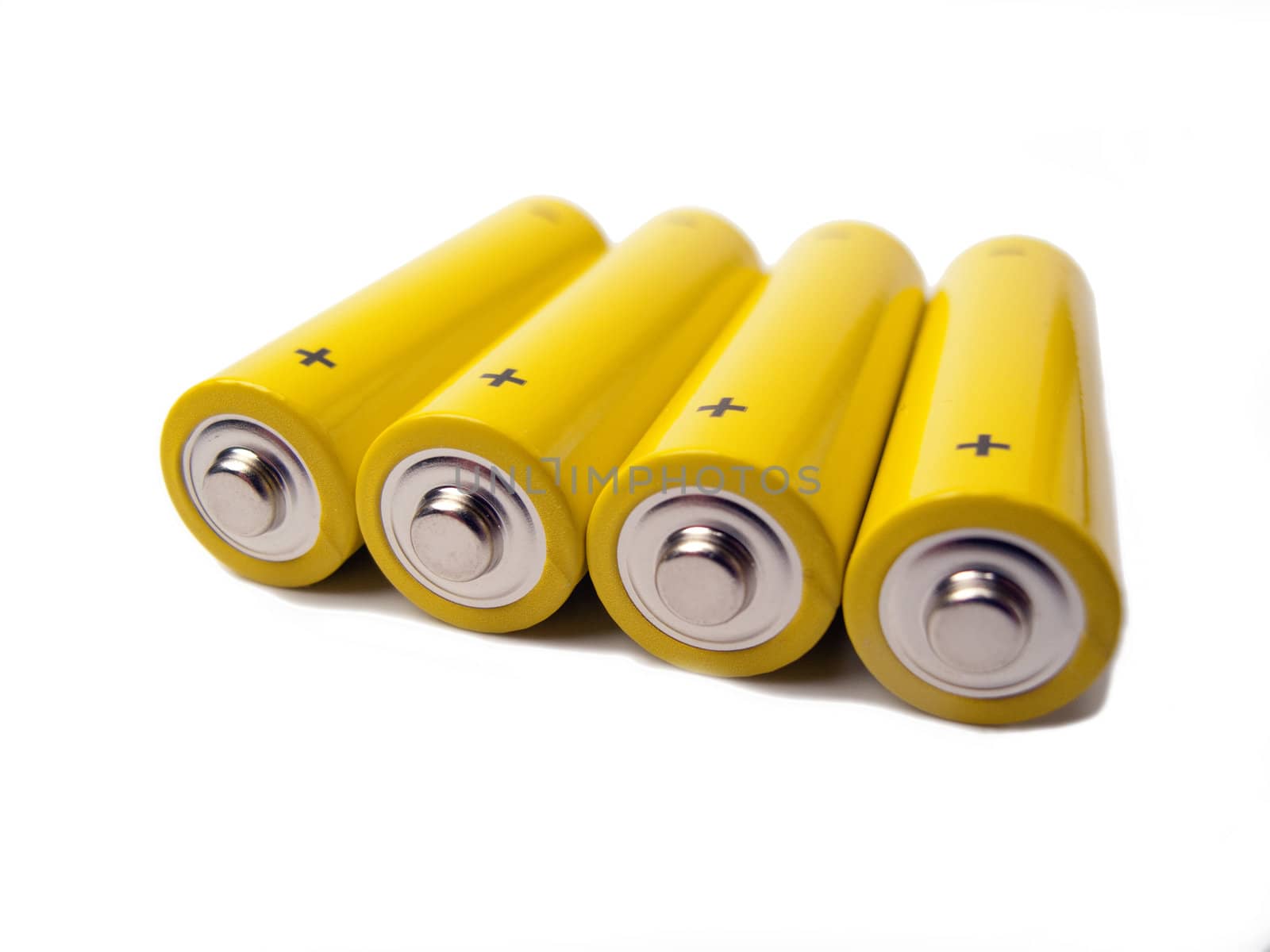 Four yellow batteries with the contacts and the plus sign showing, white background