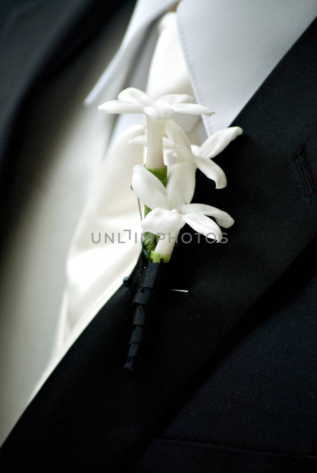 Close-up of a groom with flowers on his lapel