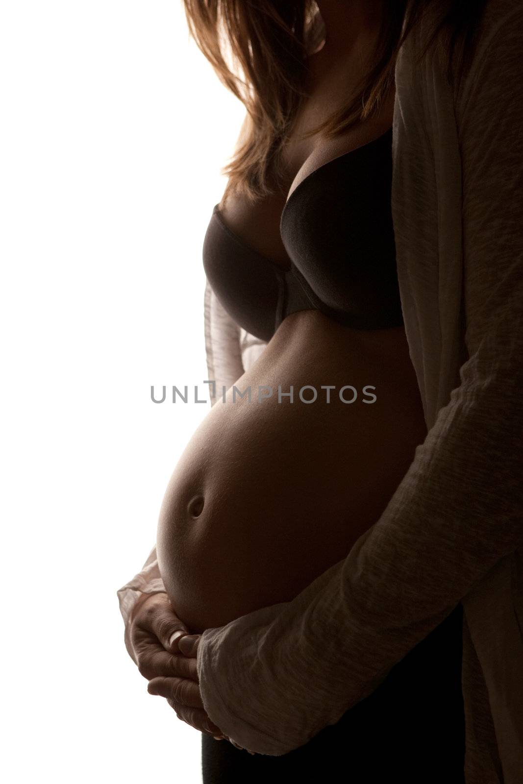 Young pregnant woman showing her belly