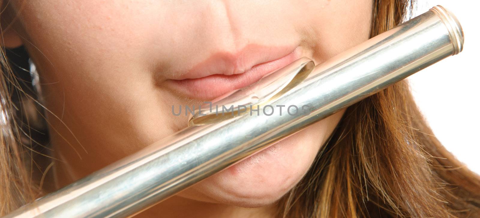 Closeup view of the way you are supposed to blow on the mouth piece of a flute for it to make noise.