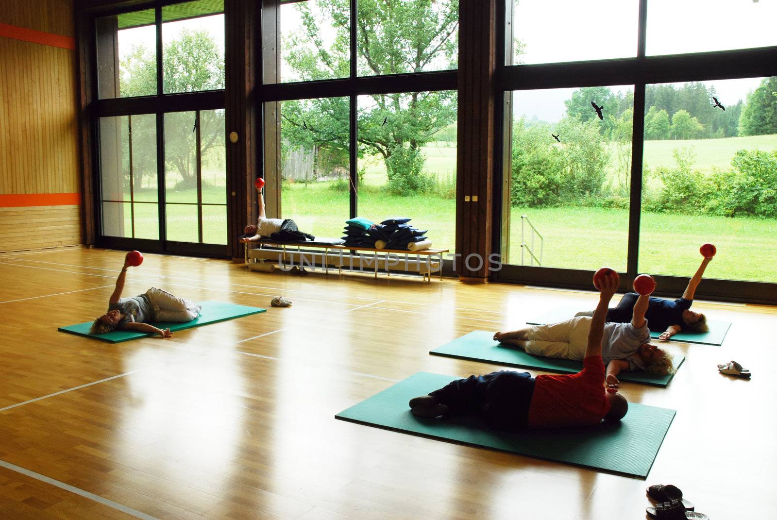 SAALFELDEN, AUSTRIA - AUGUST 30: physical therapist exercising with rheumatism patient group on August 30, 2007 at rehabilitation center in Saalfelden, Austria.