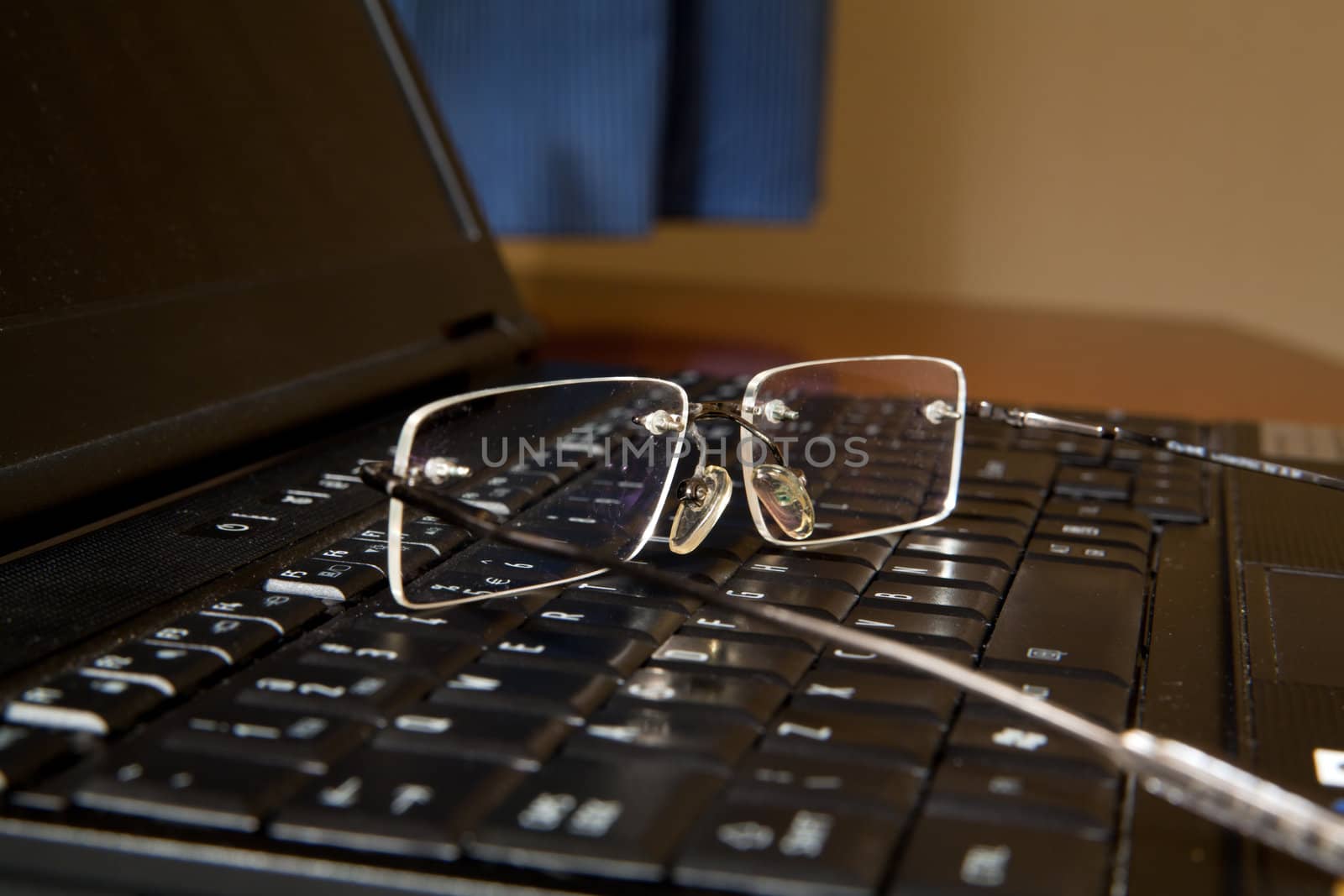 Close-up on glasses on laptop at home
