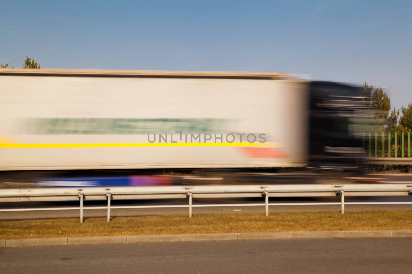 Big rig passing the highway with motion blur
