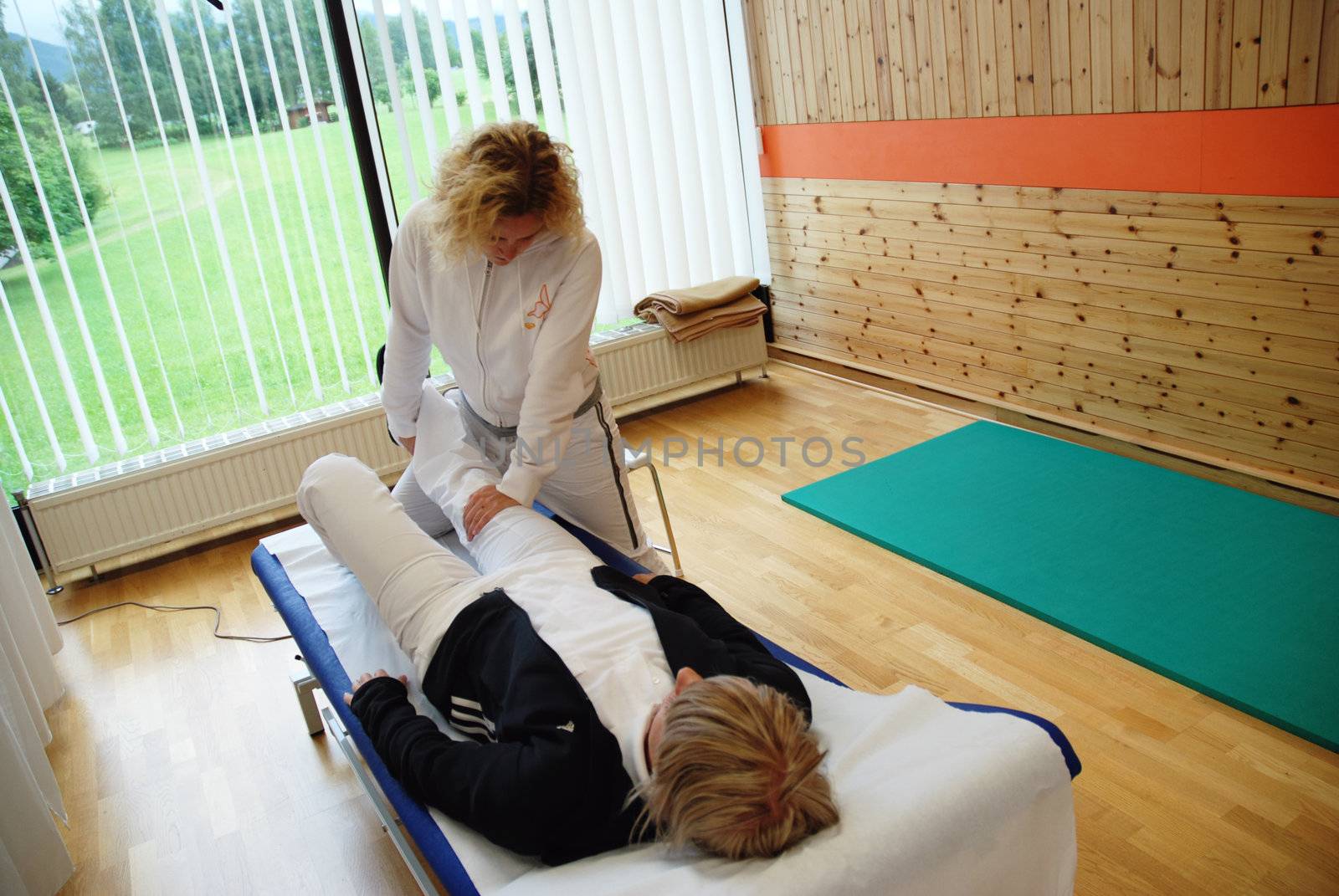 SAALFELDEN, AUSTRIA - AUGUST 30: physical therapist exercising with female rheumatism patient on August 30, 2007 at rehabilitation center in Saalfelden, Austria.