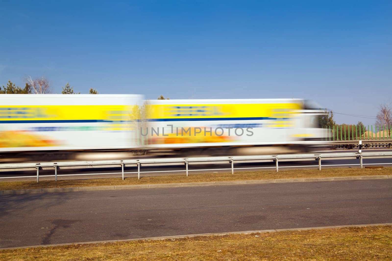 Big rig passing the highway with motion blur
