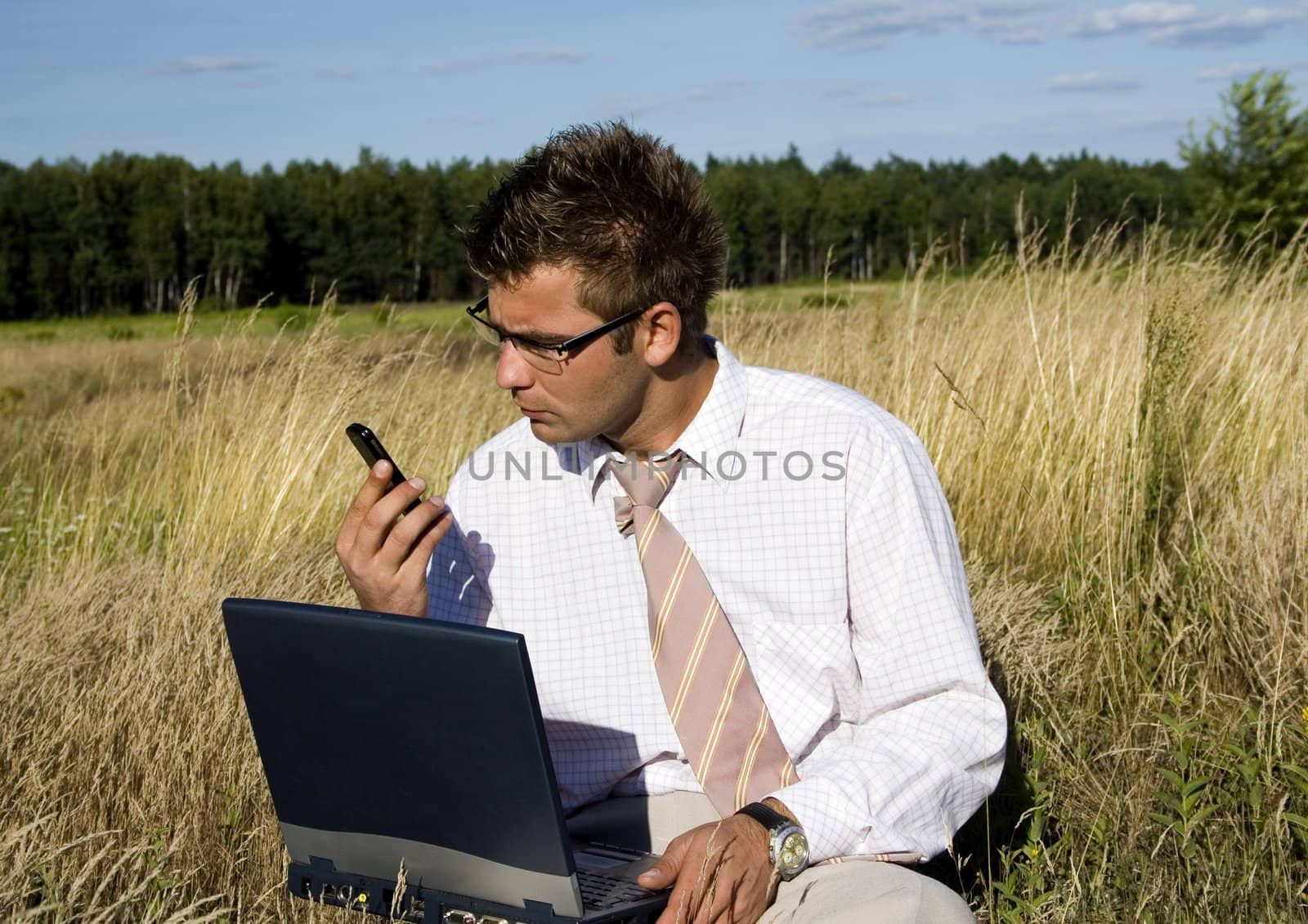 Businessman talking on mobile phone by shiffti