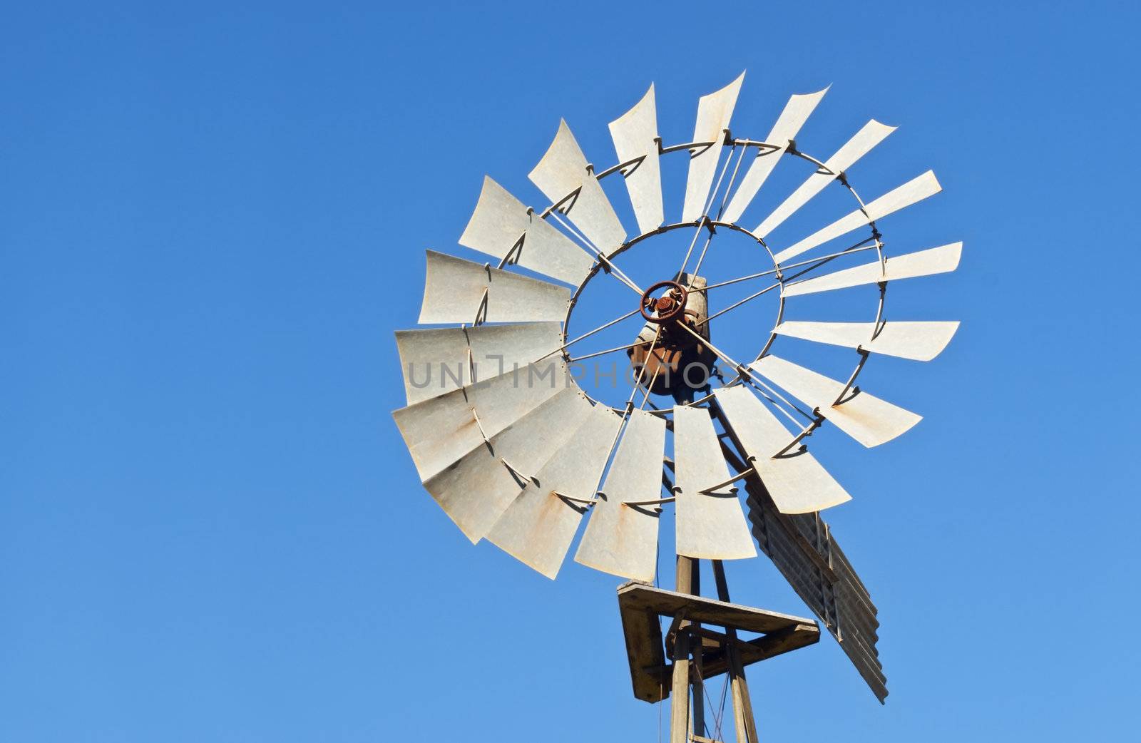 windmill against blue sky by sherj