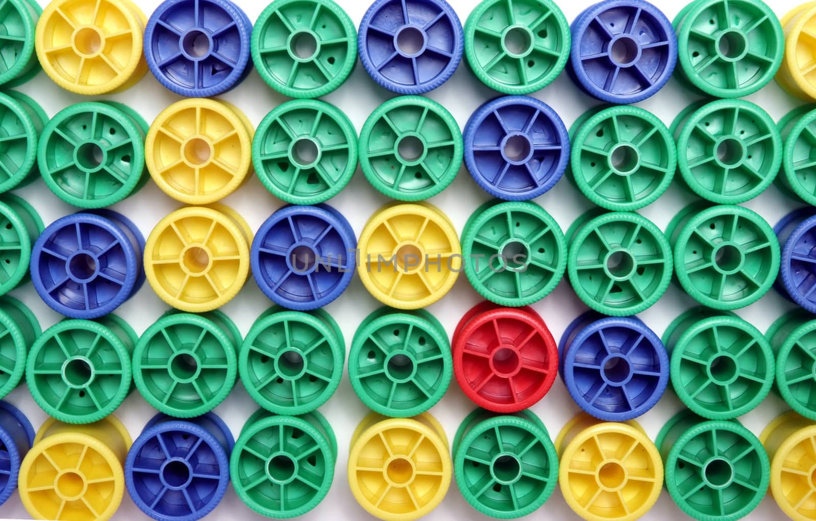 Many cotton reels on a white background