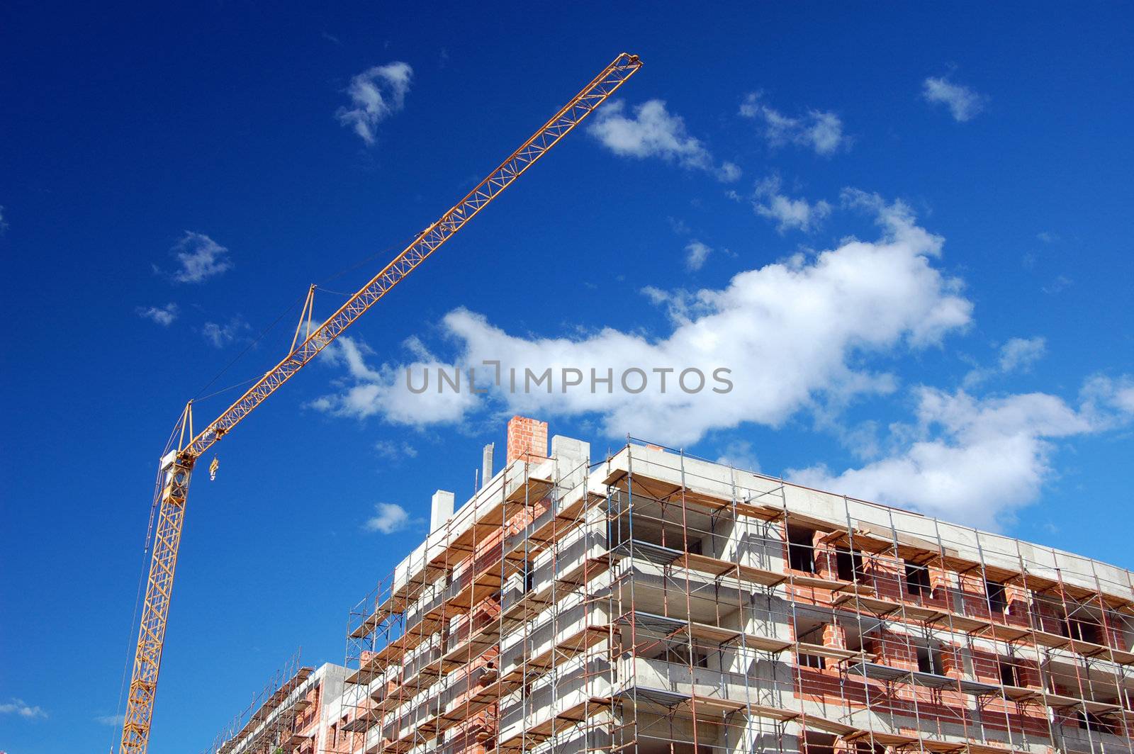 New building under construction with scaffold and crane