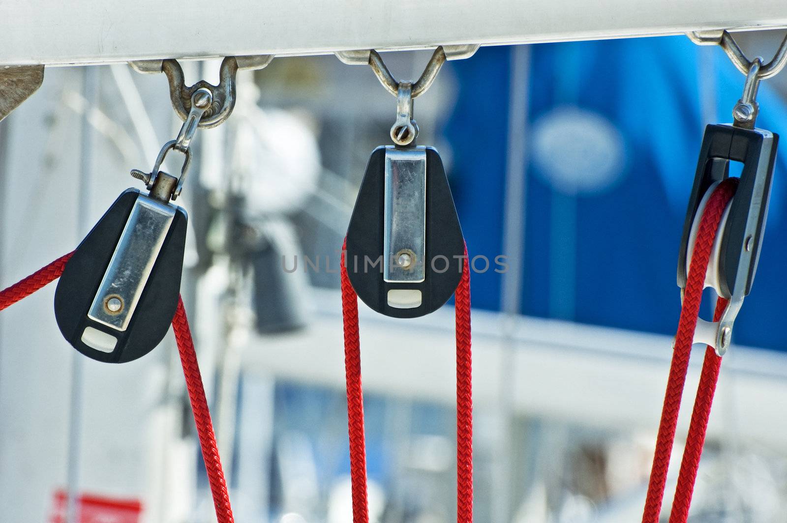 Three pulleys and red rope on a boat