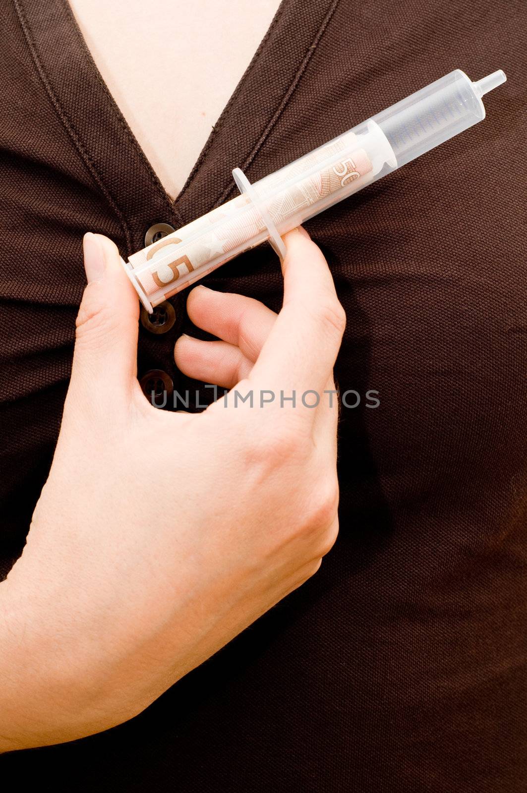 Woman holding an injection with bank notes