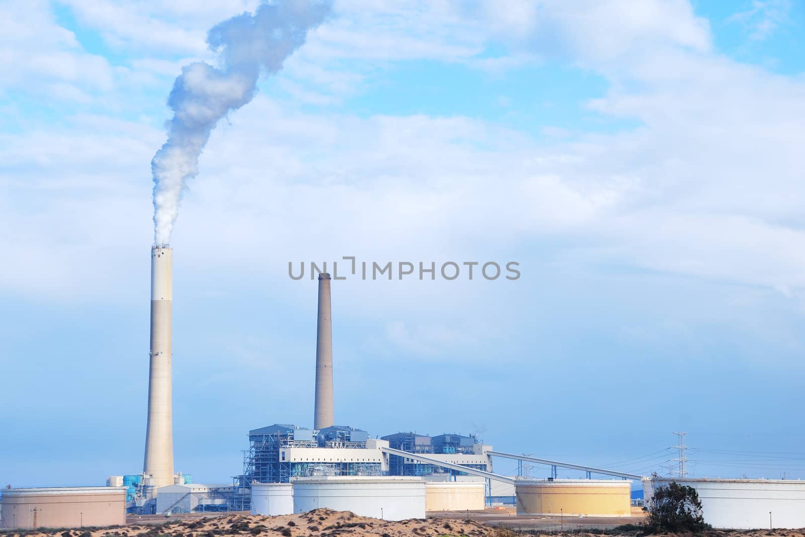 Smokestacks of power station on sky background