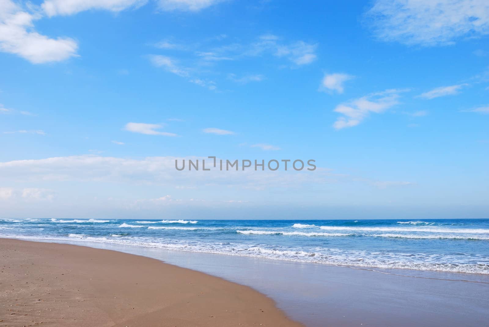 Waves running on sandy coast of Mediterranean sea