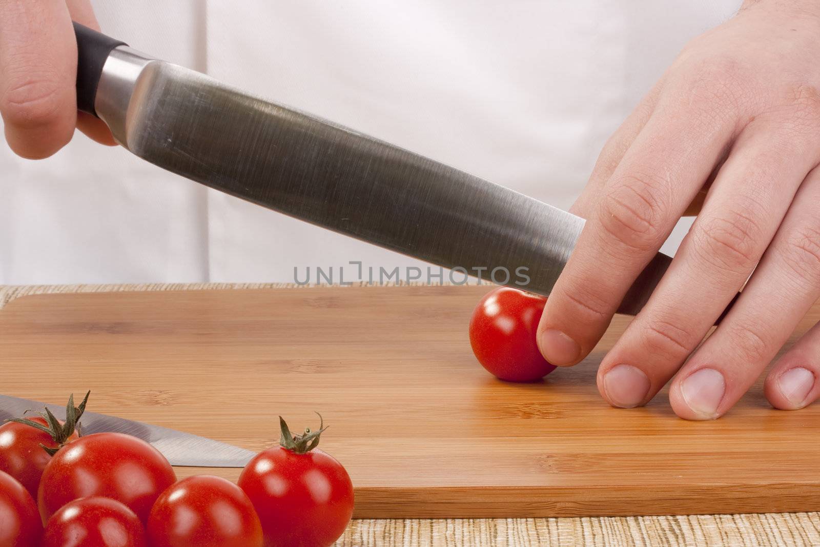 Chef Man cut vegetables on kitchen blackboard.