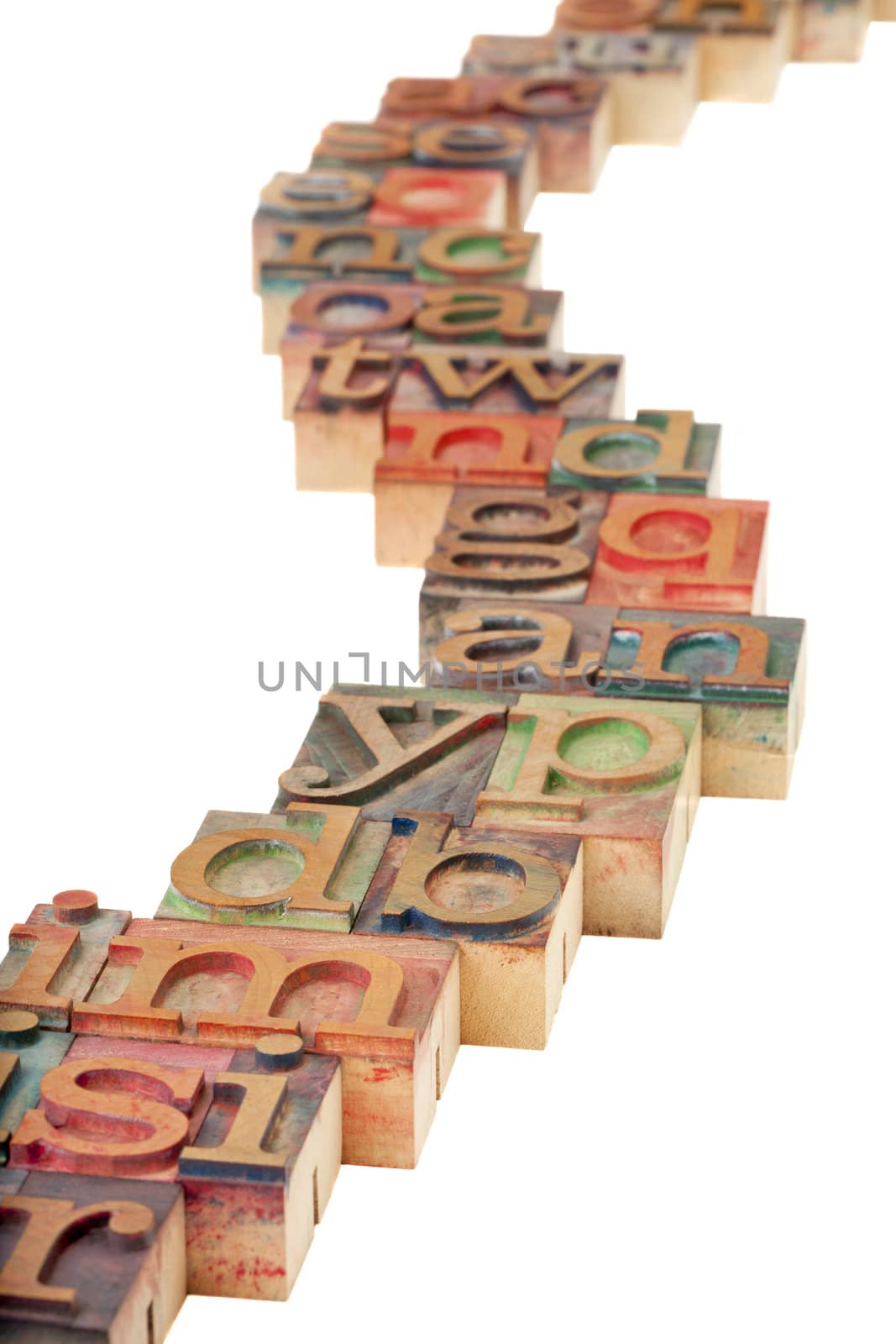 education concept - a windy pathway with vintage wooden letterpress printing blocks, isolated on white