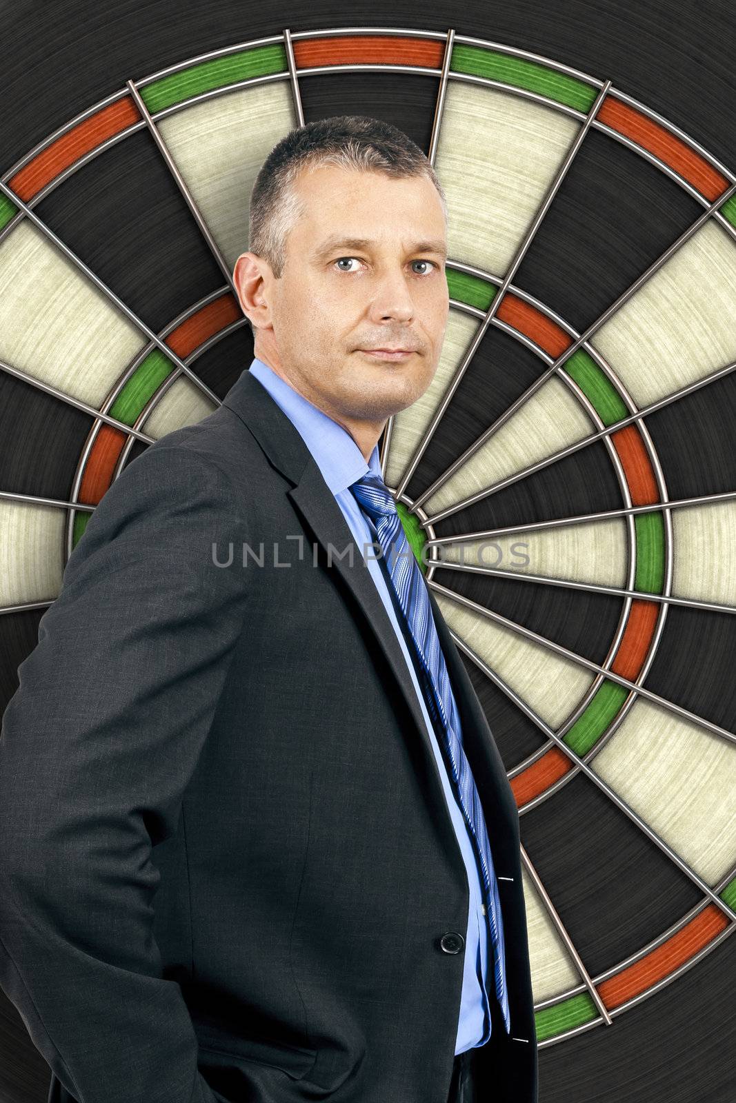 An image of a business man in front of a dartboard